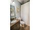 Traditional bathroom features granite countertop, framed art and brown tile flooring at 440 Canton Walk, Roswell, GA 30075