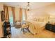 This bedroom features a chandelier, bedside tables, decorative curtains and a sitting area at 440 Canton Walk, Roswell, GA 30075