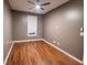 Bedroom with hardwood floors, ceiling fan, and one window covered by a shade at 440 Canton Walk, Roswell, GA 30075