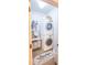 This laundry room features a stacked washer and dryer, storage, and a decorative rug at 440 Canton Walk, Roswell, GA 30075