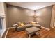 Living room with hardwood floors, and a brown sectional sofa with throw pillows at 440 Canton Walk, Roswell, GA 30075