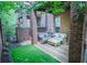 Brick patio provides seating with a view of an artificial lawn area and lovely landscaping at 440 Canton Walk, Roswell, GA 30075