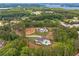 Aerial view of two luxury homes on large lots surrounded by mature trees near a lake at 6301 New Bethany Rd, Buford, GA 30518