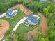 Areal view of two residences with black fences and lush lawns nestled among mature trees at 6301 New Bethany Rd, Buford, GA 30518