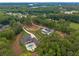 Aerial view of two large luxury homes near a lake surrounded by lush green forest at 6301 New Bethany Rd, Buford, GA 30518