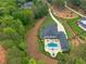 Aerial view of a modern two-story home with a private pool, patio, and fire pit area at 6301 New Bethany Rd, Buford, GA 30518