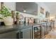 Home wet bar featuring granite countertops, under-cabinet lighting, and refrigerated beverage storage at 6301 New Bethany Rd, Buford, GA 30518