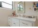 Bright bathroom featuring a white vanity with a gold faucet and a gold trimmed mirror above at 6301 New Bethany Rd, Buford, GA 30518