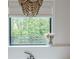 Bathroom window with blinds and view of tree line at 6301 New Bethany Rd, Buford, GA 30518