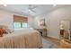 Neutral toned bedroom featuring a ceiling fan, stylish rug, and desk by the window at 6301 New Bethany Rd, Buford, GA 30518