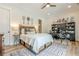 Bright bedroom with a unique headboard, a decorative rug, and a desk area with shelving for storage and display at 6301 New Bethany Rd, Buford, GA 30518