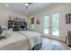 Comfortable bedroom with desk space and French doors leading to an outdoor patio area for relaxing and enjoying the view at 6301 New Bethany Rd, Buford, GA 30518