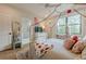 Cozy bedroom with a stylish bed, bright natural light, and access to an en-suite bathroom, featuring wood floors at 6301 New Bethany Rd, Buford, GA 30518