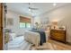 Bright bedroom featuring a ceiling fan, stylish rug, and wood furnishings at 6301 New Bethany Rd, Buford, GA 30518