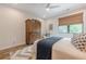 Comfortable bedroom featuring a ceiling fan, stylish rug, and a wood armoire at 6301 New Bethany Rd, Buford, GA 30518