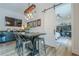 Chic dining area featuring an industrial table with seating, a wet bar, and a view into a bedroom/office through a sliding barn door at 6301 New Bethany Rd, Buford, GA 30518