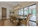 Dining room with modern light fixture, large windows overlooking the backyard at 6301 New Bethany Rd, Buford, GA 30518