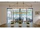Dining room with modern chandelier overlooks backyard patio at 6301 New Bethany Rd, Buford, GA 30518