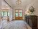 Inviting entryway with wood floors, stylish light fixture, and decorative console table at 6301 New Bethany Rd, Buford, GA 30518