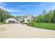 Spacious home with attached garages, circular driveway, and manicured lawn at 6301 New Bethany Rd, Buford, GA 30518
