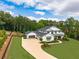 Beautiful two-story home with a well-manicured lawn, mature trees, and a circular driveway at 6301 New Bethany Rd, Buford, GA 30518