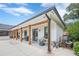 Stylish home exterior featuring a covered patio with wooden beams and comfortable outdoor seating at 6301 New Bethany Rd, Buford, GA 30518
