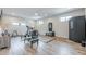 Home gym featuring a variety of workout equipment, bright lighting, and durable wood-look flooring at 6301 New Bethany Rd, Buford, GA 30518