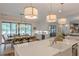 Open kitchen and dining area with large island, stainless appliances, and bar with beverage fridge at 6301 New Bethany Rd, Buford, GA 30518