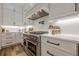 Kitchen with professional-grade stainless steel gas range and custom cabinetry at 6301 New Bethany Rd, Buford, GA 30518