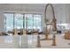 Modern kitchen faucet and soap dispensers on a white countertop, dining area in background at 6301 New Bethany Rd, Buford, GA 30518