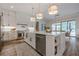 Kitchen with a large island, stainless steel appliances and adjacent dining area at 6301 New Bethany Rd, Buford, GA 30518