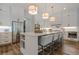 Bright kitchen features a large island with seating and stainless steel appliances at 6301 New Bethany Rd, Buford, GA 30518