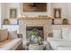 Inviting living room with brick fireplace, wood mantel, and built-in cabinets offers cozy charm at 6301 New Bethany Rd, Buford, GA 30518