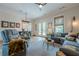 Inviting living room featuring a gray reclining chair, sofa, and access to the outdoor patio at 6301 New Bethany Rd, Buford, GA 30518