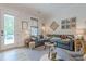 Cozy living room with a comfortable sectional sofa, natural light, and stylish decor at 6301 New Bethany Rd, Buford, GA 30518