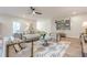 Bright living area with wood floors, a modern ceiling fan, ample seating, and stylish accents and decor at 6301 New Bethany Rd, Buford, GA 30518