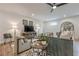 Comfortable living room with neutral tones, stylish decor, and wood flooring, with a ceiling fan above at 6301 New Bethany Rd, Buford, GA 30518