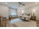 Relaxing primary bedroom featuring sitting area and large windows for natural light at 6301 New Bethany Rd, Buford, GA 30518