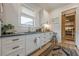 Spacious mudroom with white cabinets, countertop, sink, and barn door pantry at 6301 New Bethany Rd, Buford, GA 30518
