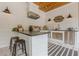 Outdoor kitchen on the porch includes stainless steel appliances, countertop, and bar seating at 6301 New Bethany Rd, Buford, GA 30518