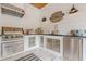 Built-in outdoor kitchen on the porch with stainless steel appliances and counter space at 6301 New Bethany Rd, Buford, GA 30518