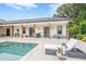 Relaxing pool area featuring a sun lounger, well-maintained landscaping, and a covered patio at 6301 New Bethany Rd, Buford, GA 30518