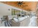 Expansive screened porch featuring a wood ceiling, multiple seating areas, and an outdoor kitchen at 6301 New Bethany Rd, Buford, GA 30518
