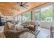 Large screened porch with wood ceiling, comfortable seating, and views of the backyard at 6301 New Bethany Rd, Buford, GA 30518