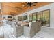 Outdoor screened porch with living and dining areas, TV, and views of backyard and outdoor kitchen at 6301 New Bethany Rd, Buford, GA 30518