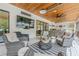 Spacious screened porch features an outdoor living area, TV, and a built-in outdoor kitchen at 6301 New Bethany Rd, Buford, GA 30518