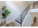 Modern staircase with sleek railings, contemporary lighting, and stylish hardwood flooring at 6301 New Bethany Rd, Buford, GA 30518