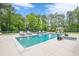 Inviting swimming pool with ample lounge seating and a serene wooded backdrop at 6301 New Bethany Rd, Buford, GA 30518