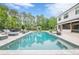 Beautiful backyard swimming pool with a pristine lawn and views of the home's exterior at 6301 New Bethany Rd, Buford, GA 30518