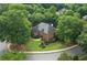 Aerial view showcases a stunning home with a well-manicured lawn, mature trees, and a welcoming facade, providing curb appeal at 9595 Rod Rd, Alpharetta, GA 30022
